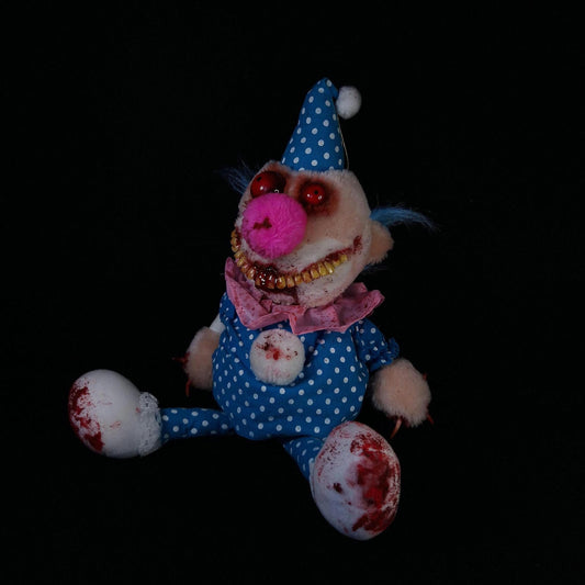 Clown with creepy bloody smile and red bloodshot eyes