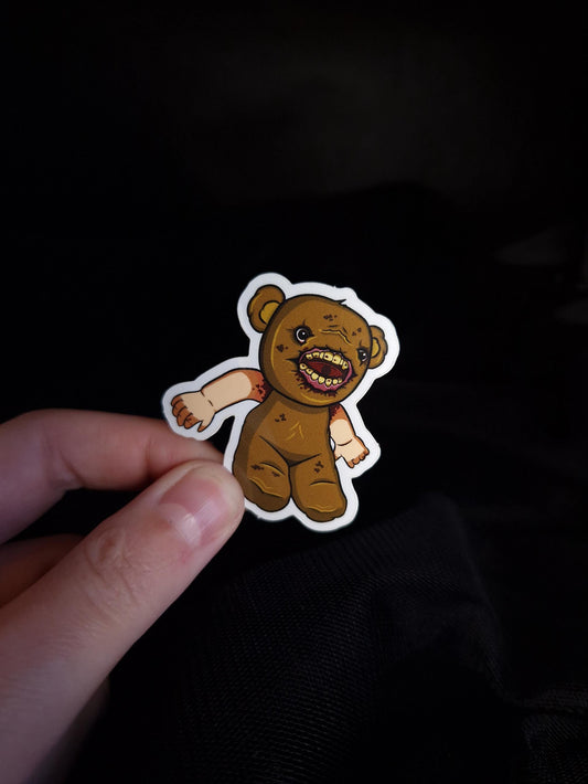 Teddy bear sticker with human mouth and baby arms 