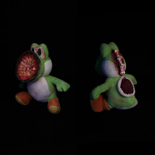 Yoshi Nintendo plushie with mouth as hose and spine coming out of his head 
